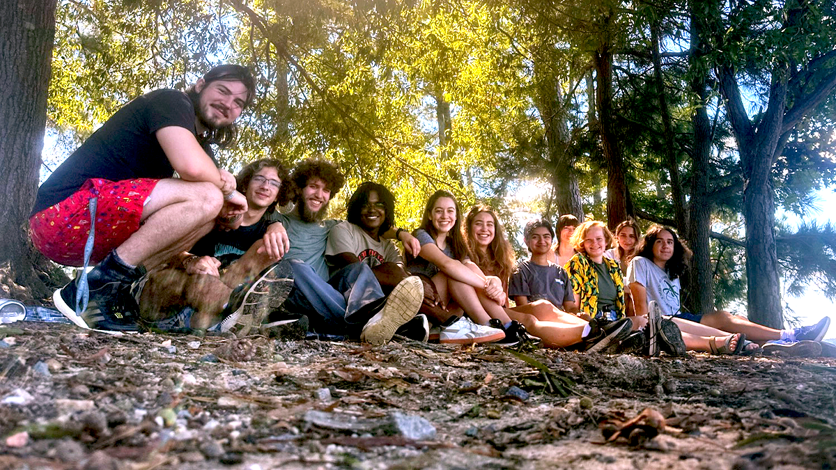 A group of student, that are a part of the Visibility in Physics club, pose for a student at Jordan Lake.